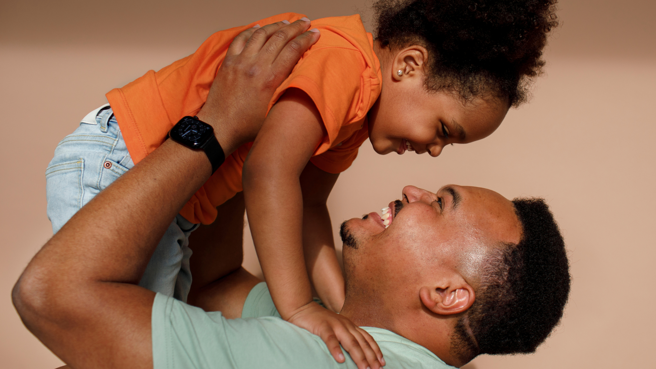 a father lifting his daughter