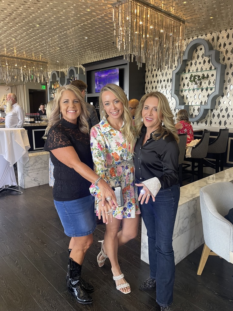 Three women posing and showing rings at Diamonds & Denim 2025 San Diego fundraising event