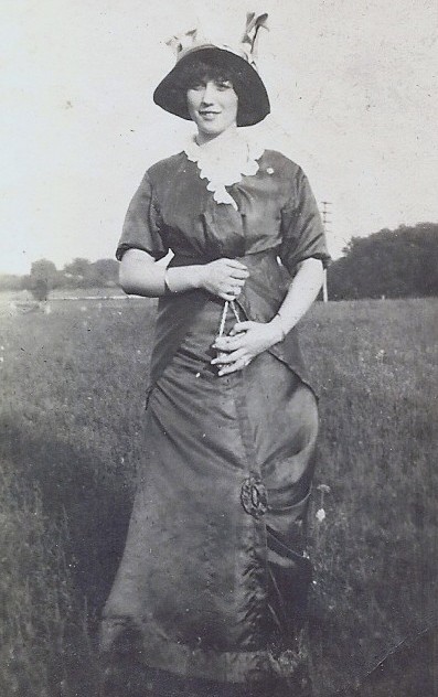 A woman from the early 1900s showing that she is pregnant. 
