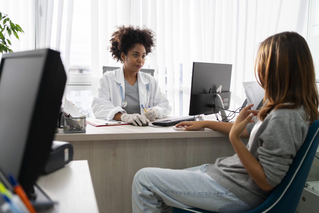 woman talking to doctor about health insurance