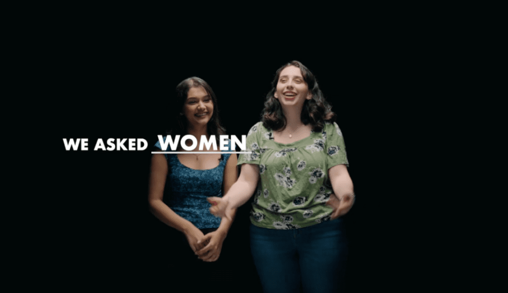 Two women smile and react during an interview-style segment of For Every Woman's Core Vision Video. On-screen text reads, "We Asked Women."