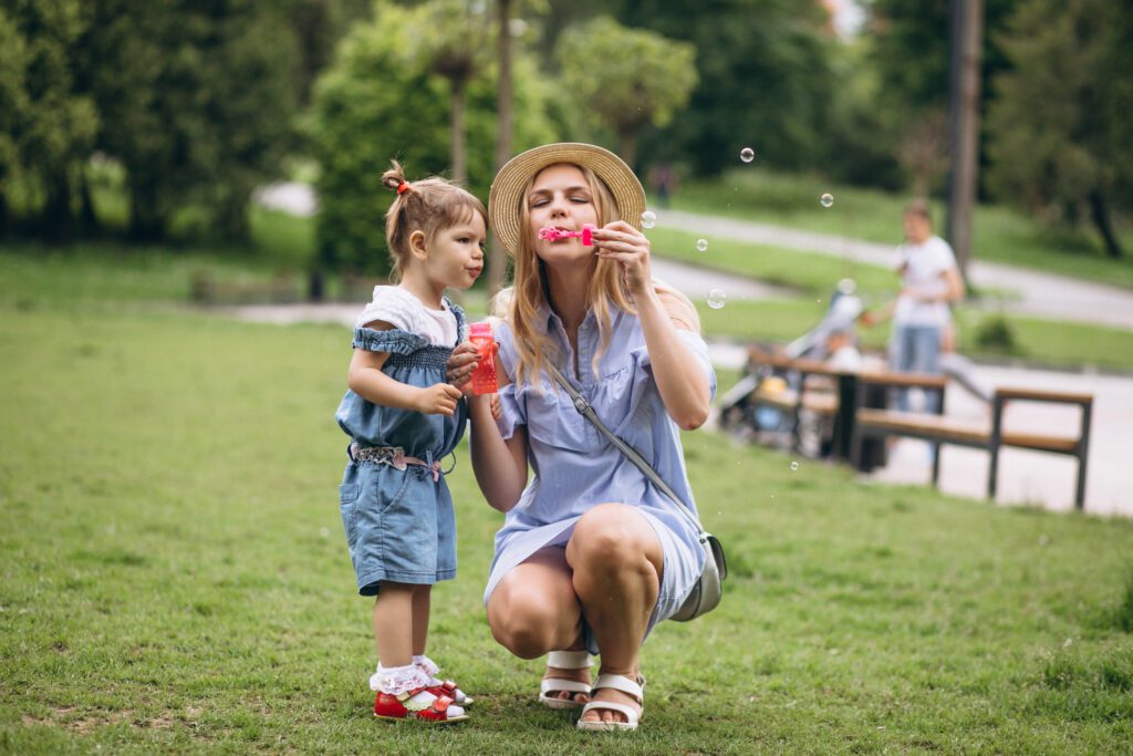 mom having fun with child during summer