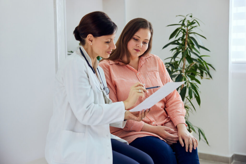 a woman talking to her doctor about ovulation