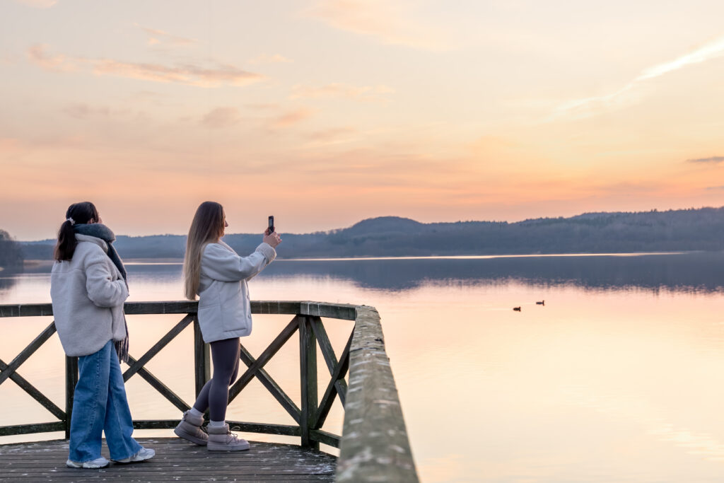 friends watching sunset as part of their ultimate sisterhood bucket list