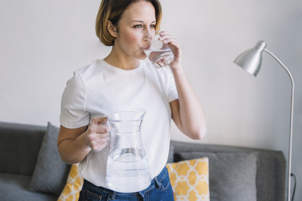 woman hydrating before hysterectomy surgery