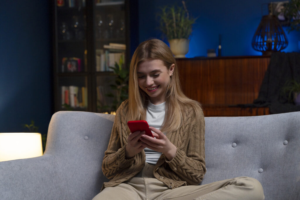 woman texting friend while watching a movie ultimate sisterhood bucket list